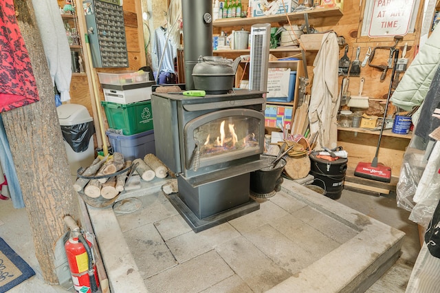76 Meceola Ct, Hersey, MI 49639 - detailed view of a wood stove and a fire extinguisher