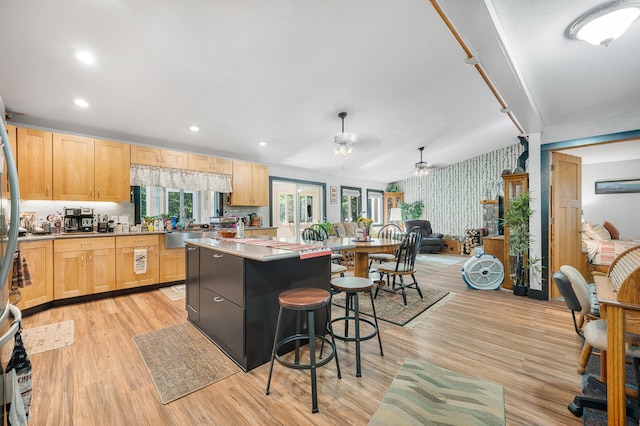 76 Meceola Ct, Hersey, MI 49639 - kitchen featuring wallpapered walls, a kitchen breakfast bar, a ceiling fan, open floor plan, and light brown cabinets