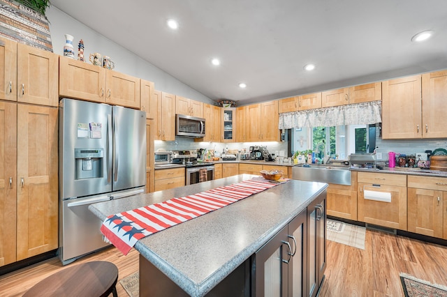 76 Meceola Ct, Hersey, MI 49639 - kitchen with appliances with stainless steel finishes, light brown cabinetry, light wood-style flooring, recessed lighting, and vaulted ceiling