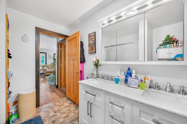 76 Meceola Ct, Hersey, MI 49639 - bathroom featuring double vanity and stone finish flooring