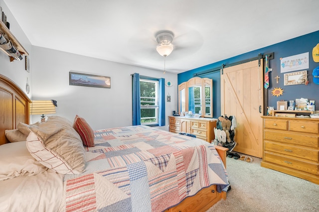 76 Meceola Ct, Hersey, MI 49639 - bedroom with light colored carpet, a barn door, and a ceiling fan
