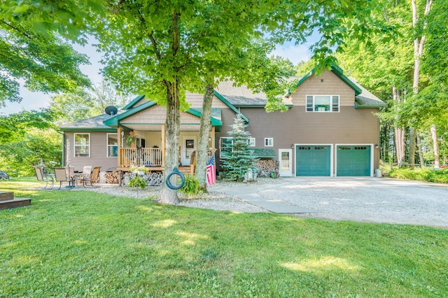 76 Meceola Ct, Hersey, MI 49639 - view of front of property featuring an attached garage, driveway, a front lawn, and a porch
