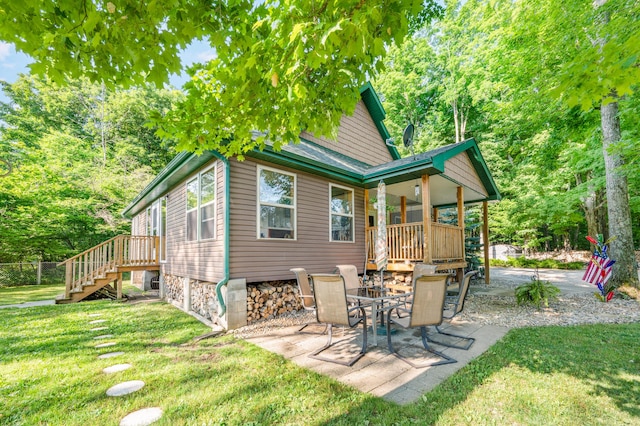 76 Meceola Ct, Hersey, MI 49639 - rear view of house with a yard, a patio, and stairway