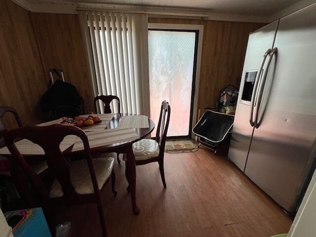 1325 Maude Ave NE, Grand Rapids, MI 49505 - dining space featuring wooden walls and light wood-style floors