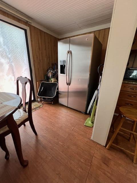 1325 Maude Ave NE, Grand Rapids, MI 49505 - dining room with wood walls and light wood-style flooring