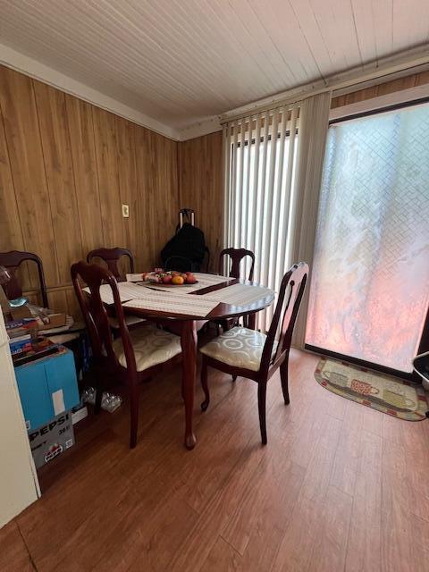 1325 Maude Ave NE, Grand Rapids, MI 49505 - dining space featuring wood walls and wood finished floors