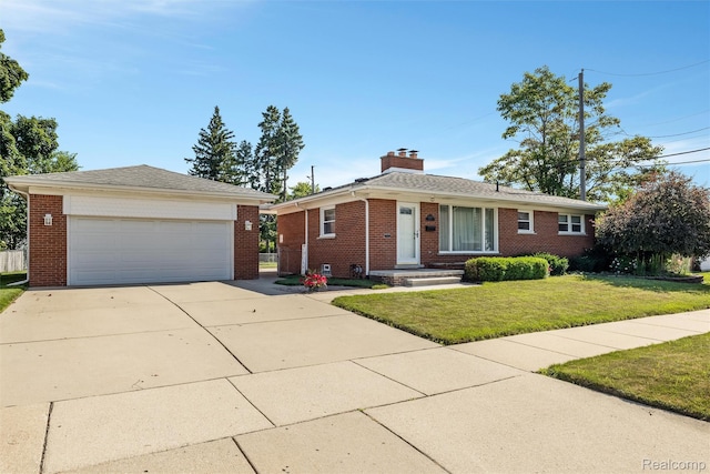 1024 London Ave, Lincoln Park, MI 48146 - view of front of house featuring brick siding, a chimney, a front yard, and an outbuilding