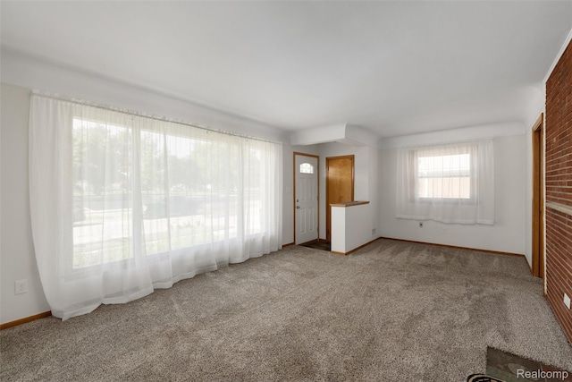 1024 London Ave, Lincoln Park, MI 48146 - unfurnished living room featuring carpet and baseboards