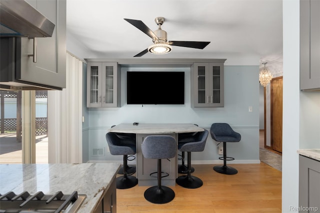 1024 London Ave, Lincoln Park, MI 48146 - bar with exhaust hood, light wood-type flooring, and a ceiling fan