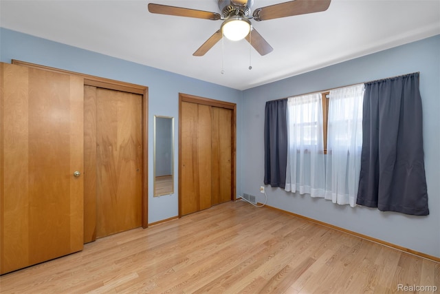 1024 London Ave, Lincoln Park, MI 48146 - unfurnished bedroom featuring two closets, wood finished floors, and ceiling fan