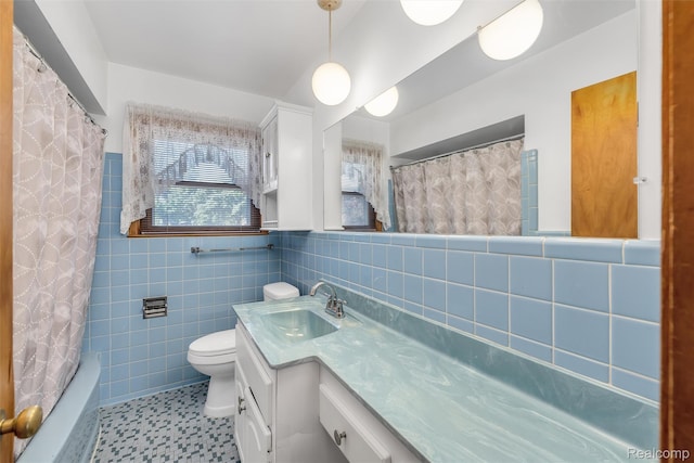 1024 London Ave, Lincoln Park, MI 48146 - full bathroom featuring tile walls, vanity, shower / bath combination with curtain, a wainscoted wall, and tile patterned floors