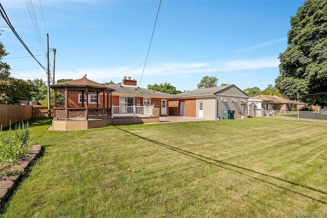 1024 London Ave, Lincoln Park, MI 48146 - rear view of property featuring a gazebo, brick siding, a fenced backyard, a wooden deck, and a patio