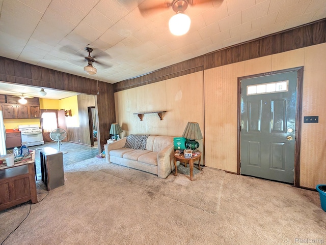 1402 Allen St, Burton, MI 48529 - living room featuring a ceiling fan, light carpet, and wood walls