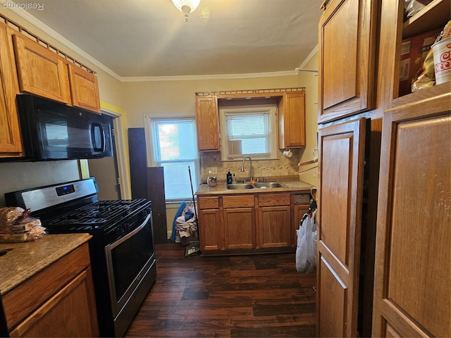 4417 Elizabeth St, Wayne, MI 48184 - kitchen with stainless steel gas range, black microwave, crown molding, dark wood-type flooring, and tasteful backsplash