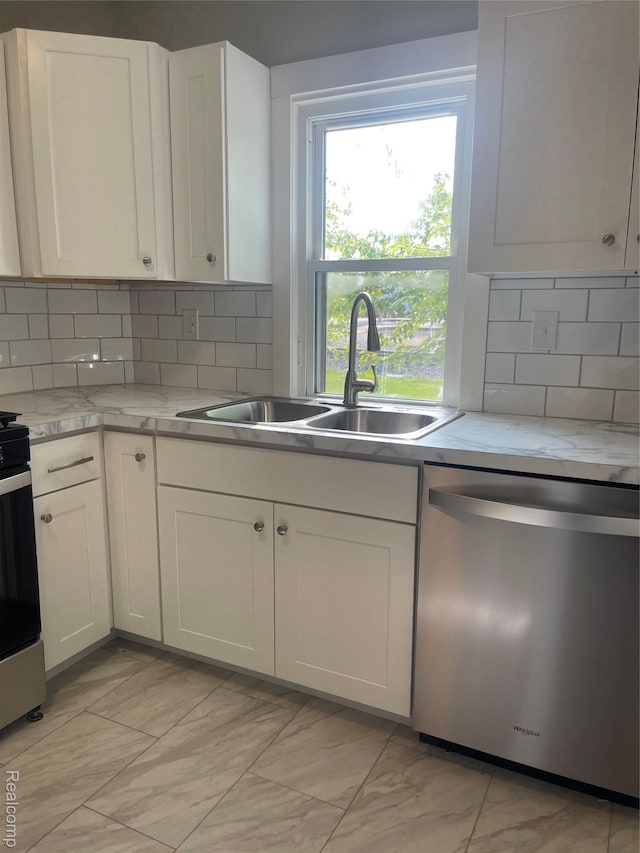 160 Emmons Blvd, Wyandotte, MI 48192 - kitchen with stainless steel appliances, light marble finish floors, tasteful backsplash, and white cabinetry