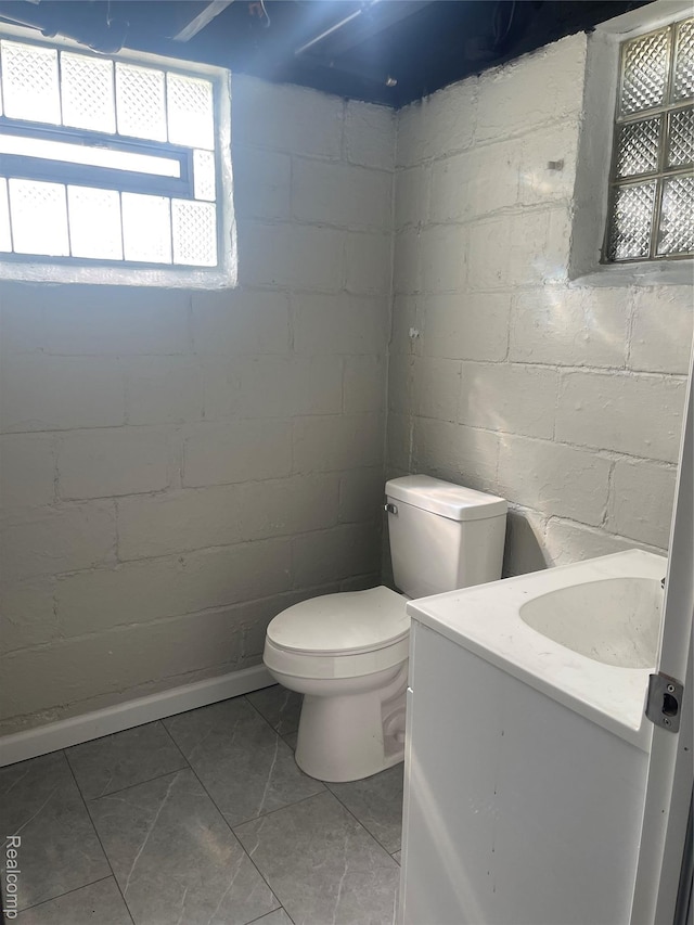 160 Emmons Blvd, Wyandotte, MI 48192 - bathroom featuring vanity, concrete block wall, and tile patterned flooring