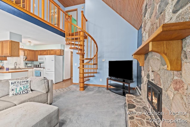 331 Conkey Dr, Michigan, MI 48834 - living room with high vaulted ceiling, wood ceiling, stairway, light colored carpet, and a stone fireplace