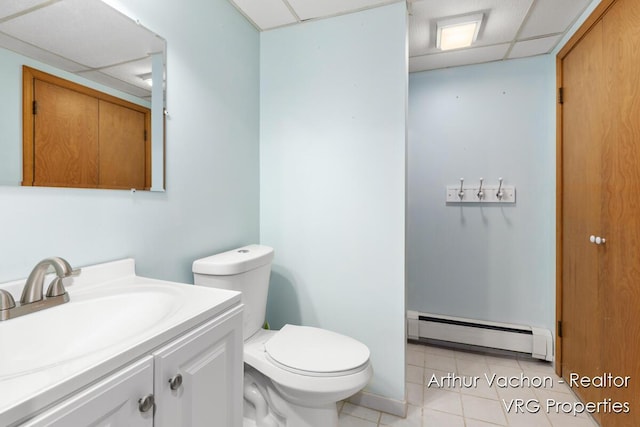 331 Conkey Dr, Michigan, MI 48834 - half bathroom with a baseboard heating unit, a drop ceiling, tile patterned floors, and vanity