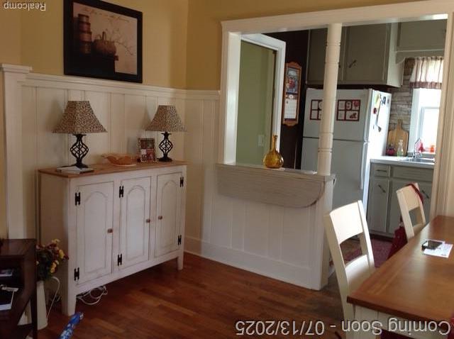 1431 Denies St, Burton, MI 48509 - dining room featuring a decorative wall, dark wood-style floors, a wainscoted wall, and decorative columns