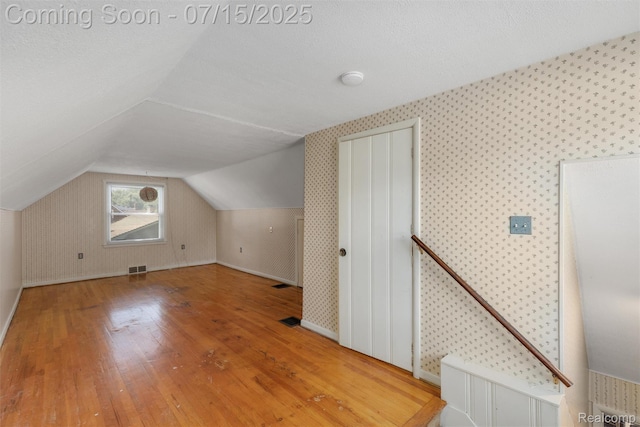 20225 Shady Lane Ave, Saint Clair Shores, MI 48080 - additional living space with hardwood / wood-style flooring, wallpapered walls, and vaulted ceiling