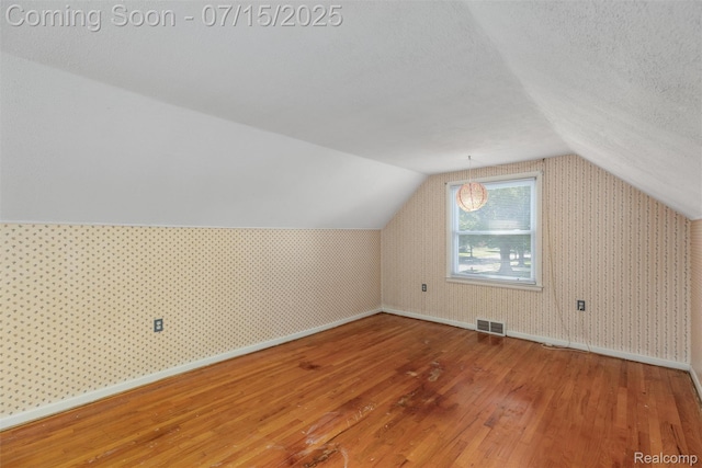20225 Shady Lane Ave, Saint Clair Shores, MI 48080 - bonus room featuring wood finished floors, lofted ceiling, a textured ceiling, and wallpapered walls
