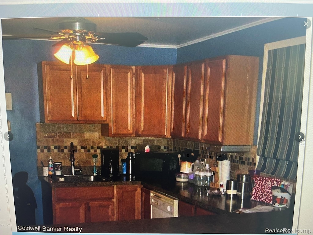 14086 Hendricks Ave, Warren, MI 48089 - kitchen with black microwave, ceiling fan, dishwasher, brown cabinets, and dark countertops
