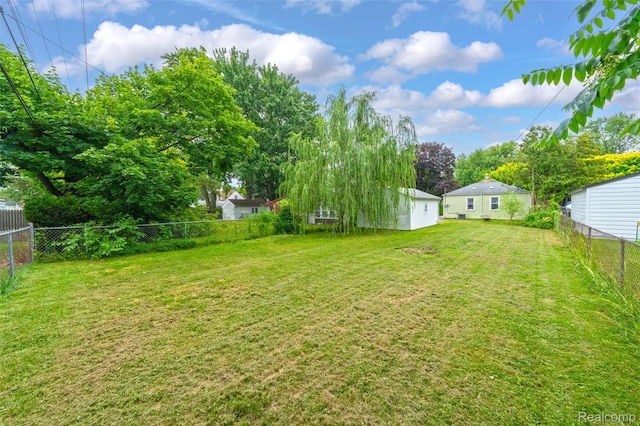 18379 Hazelwood St, Roseville, MI 48066 - fenced backyard with a detached garage and view of wooded area