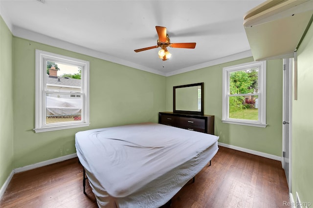 18379 Hazelwood St, Roseville, MI 48066 - bedroom with multiple windows, dark wood-style flooring, and ceiling fan