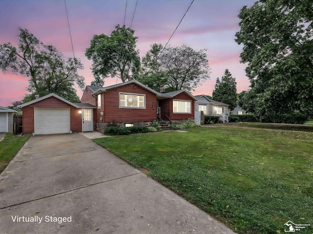 5825 Edgewood Blvd, Monroe, MI 48161 - view of front of home with a yard, concrete driveway, and a garage