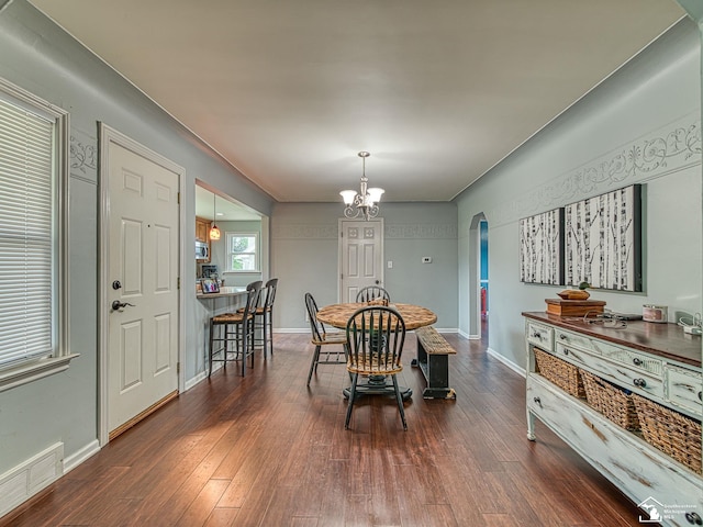5825 Edgewood Blvd, Monroe, MI 48161 - dining room featuring arched walkways, dark wood-style flooring, and a chandelier