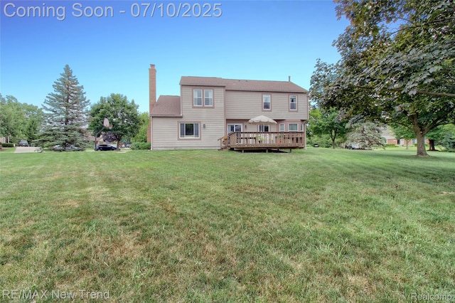 21905 Roxbury Dr, Novi, MI 48374 - back of property with a chimney, a wooden deck, and a yard
