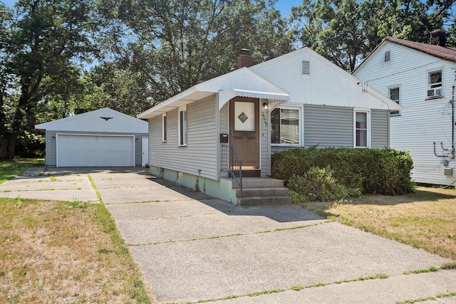 2329 Moon St, Muskegon, MI 49441 - bungalow-style home featuring an outdoor structure, a detached garage, and a chimney