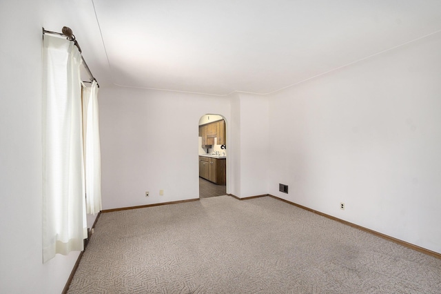 2329 Moon St, Muskegon, MI 49441 - unfurnished room with arched walkways and light carpet