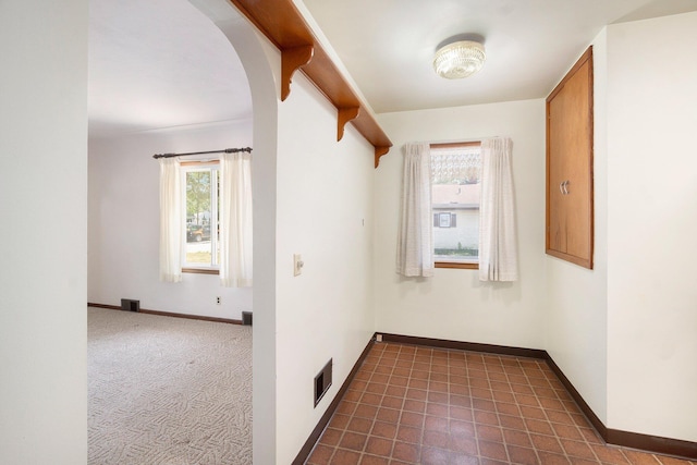 2329 Moon St, Muskegon, MI 49441 - hallway featuring plenty of natural light and arched walkways