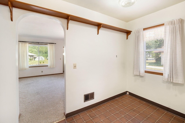 2329 Moon St, Muskegon, MI 49441 - spare room with arched walkways and baseboards