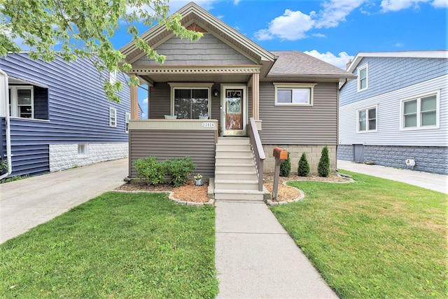 23926 Elmira St, Saint Clair Shores, MI 48082 - view of front of property with a front yard, a shingled roof, and a porch