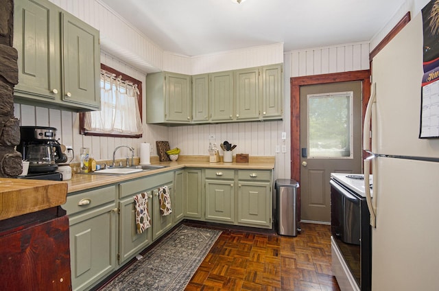 23926 Elmira St, Saint Clair Shores, MI 48082 - kitchen featuring green cabinets, white appliances, light countertops, and wooden walls