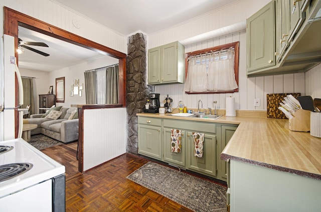 23926 Elmira St, Saint Clair Shores, MI 48082 - kitchen featuring green cabinetry, white appliances, light countertops, a ceiling fan, and wooden walls
