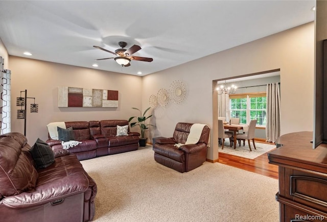 12151 Vergennes St, Lowell, MI 49331 - carpeted living room with ceiling fan, a chandelier, recessed lighting, and wood finished floors