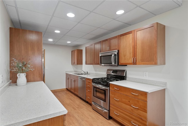 12151 Vergennes St, Lowell, MI 49331 - kitchen featuring stainless steel appliances, light wood finished floors, light countertops, brown cabinetry, and recessed lighting