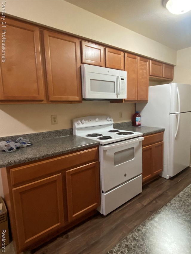 24857 Auburn Ln, Southfield, MI 48033 - kitchen with white appliances, dark countertops, brown cabinetry, and dark wood-style flooring