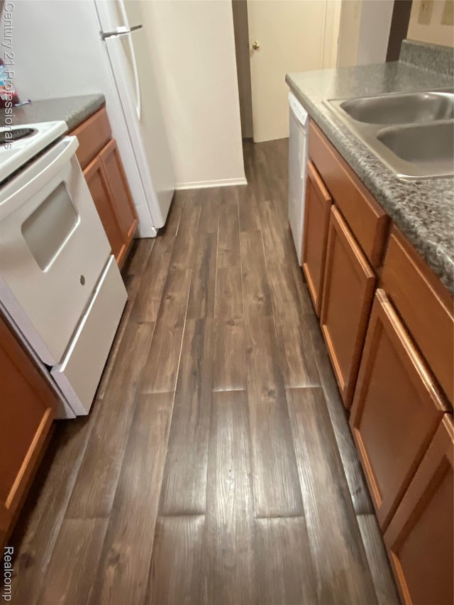 24857 Auburn Ln, Southfield, MI 48033 - kitchen featuring white appliances, dark wood-type flooring, and brown cabinetry