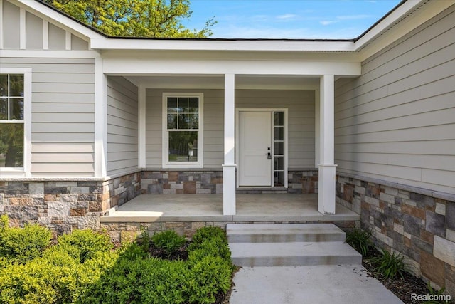 7268 Elizabeth Lake Rd, Waterford, MI 48327 - view of exterior entry featuring a porch and stone siding