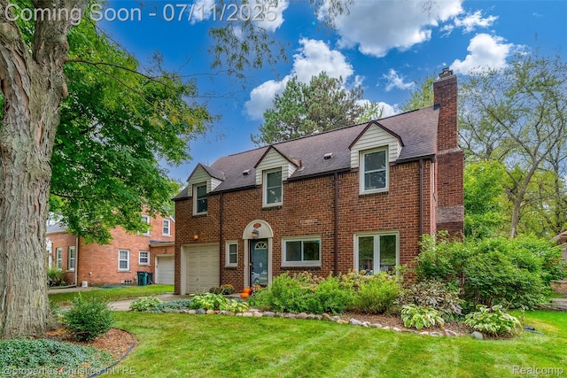 27461 Goldengate Dr W, Lathrup Village, MI 48076 - view of front facade with brick siding, a front lawn, a chimney, and a garage