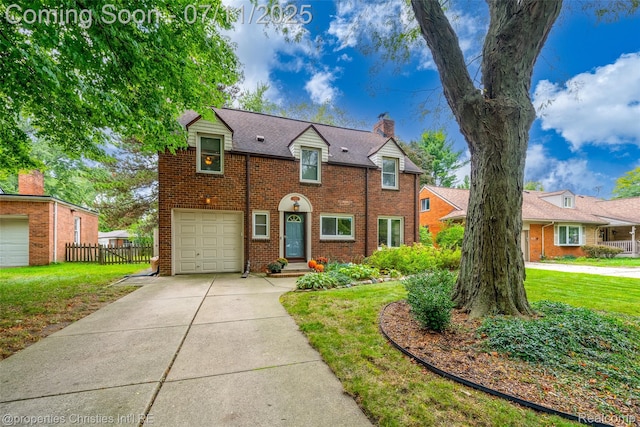 27461 Goldengate Dr W, Lathrup Village, MI 48076 - view of front facade with a chimney, brick siding, an attached garage, and concrete driveway