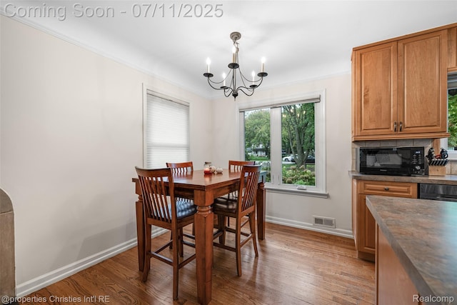 27461 Goldengate Dr W, Lathrup Village, MI 48076 - dining area featuring a chandelier, wood finished floors, and ornamental molding