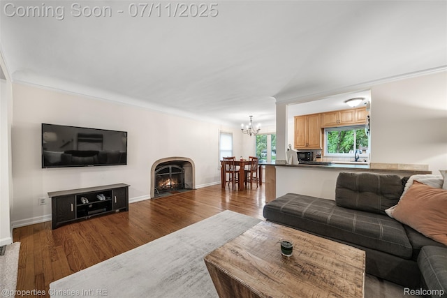 27461 Goldengate Dr W, Lathrup Village, MI 48076 - living area with a chandelier, wood finished floors, and a warm lit fireplace