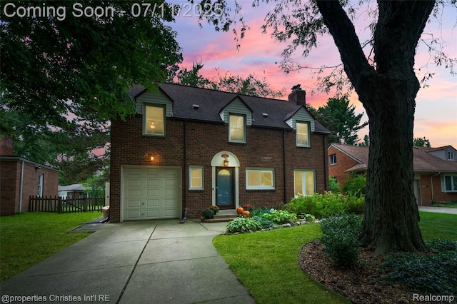 27461 Goldengate Dr W, Lathrup Village, MI 48076 - view of front facade with an attached garage, a chimney, brick siding, and concrete driveway