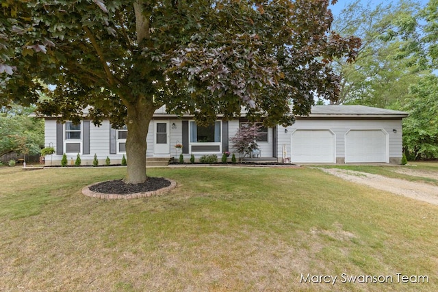 4172 Ranchero Dr, Dorr, MI 49323 - view of property hidden behind natural elements with driveway, an attached garage, and a front yard