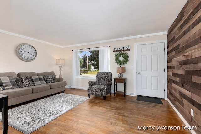 4172 Ranchero Dr, Dorr, MI 49323 - living area with wood walls, wood finished floors, and ornamental molding